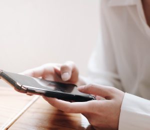 young Asia woman working with smart phone in office. young Asia woman working with smart phone in office.